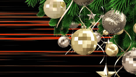 Bauble-decorations-on-christmas-tree-against-orange-light-trails-against-black-background