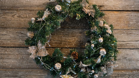 Animation-of-snow-falling-over-wreath-and-christmas-decoration
