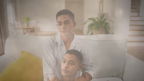 Animation-of-light-spots-over-happy-biracial-male-gay-couple