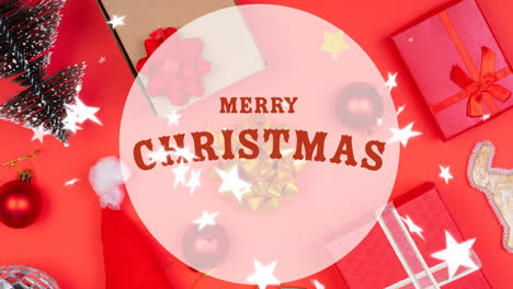 Animation-of-merry-christmas-text-over-christmas-decoration-and-presents-on-table