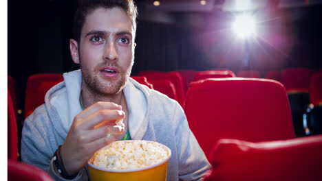 Animation-of-caucasian-man-eating-popcorn-in-cinema