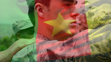 Animation-of-flag-of-cameroon-waving-over-diverse-soldiers