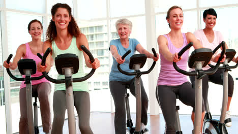 Group-of-smiling-women-in-doing-a-spinning-class