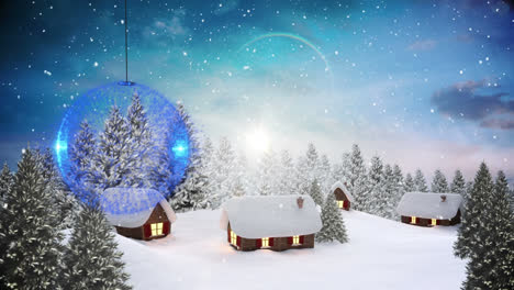 Blue-bauble-decoration-hanging-against-snow-falling-over-winter-landscape