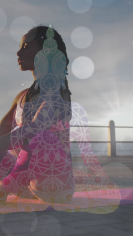 White-spots-of-light-falling-against-african-american-fit-woman-performing-yoga-on-the-promenade