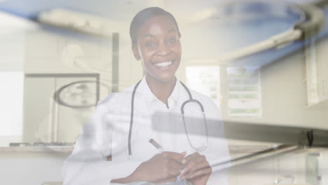 Composite-of-smiling-female-doctor-talking-in-video-consultation,-and-stethoscope-on-desk