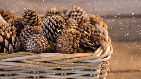 Animation-of-snow-falling-over-pine-cones-in-bascket
