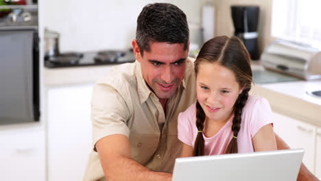 Father-using-the-laptop-with-his-daughter