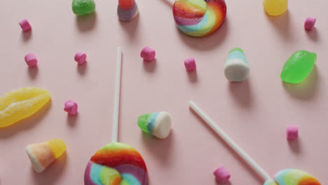 Video-of-colourful-various-sweets-on-pink-background