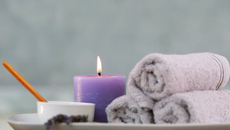 Beauty-treatment-in-bowl-presented-on-plate-with-candle