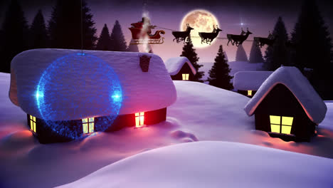 Blue-bauble-decoration-hanging-against-snow-falling-over-houses-on-winter-landscape-and-night-sky