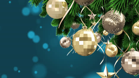 Christmas-decorations-hanging-on-christmas-tree-against-spots-of-light-on-blue-background