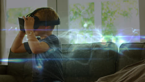 Animation-of-light-trails-over-caucasian-boy-using-vr-headset