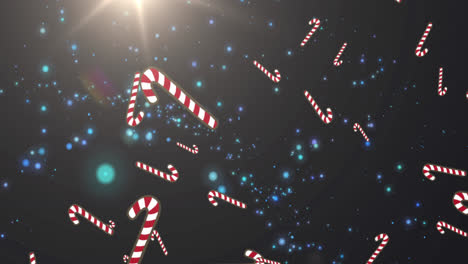 Multiple-candy-cane-icons-falling-against-blue-spots-of-light-on-black-background