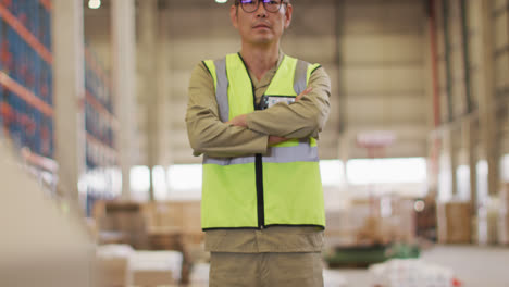 Portrait-of-asian-male-worker-wearing-safety-suit-in-warehouse