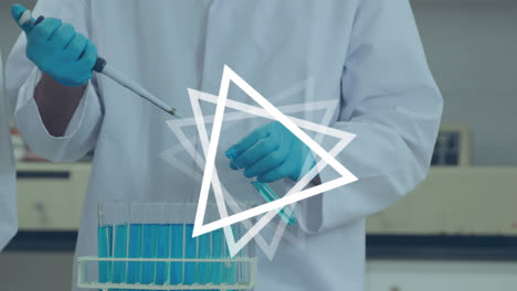 Animation-of-white-triangles-over-male-doctor-working-in-lab