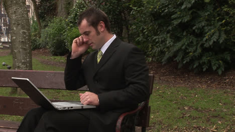 Man-Working-in-Park-on-Laptop