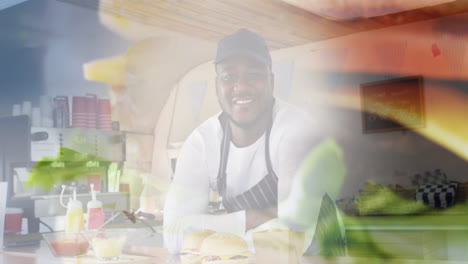 Composite-of-smiling-african-american-chef,-and-hamburger