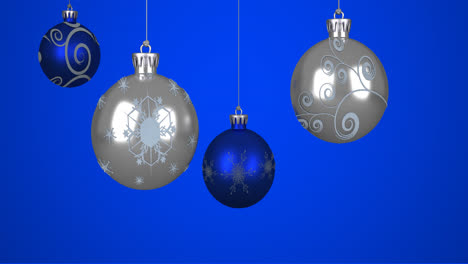 Animation-of-christmas-baubles-over-blue-background