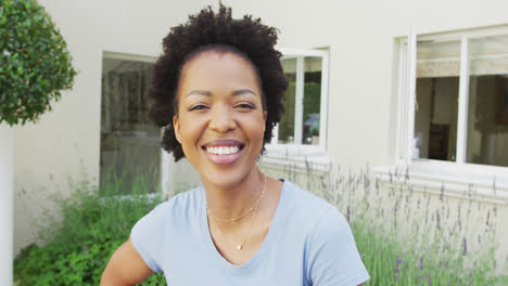 Porträt-Einer-Lächelnden-Afroamerikanischen-Frau,-Die-Im-Garten-In-Die-Kamera-Blickt