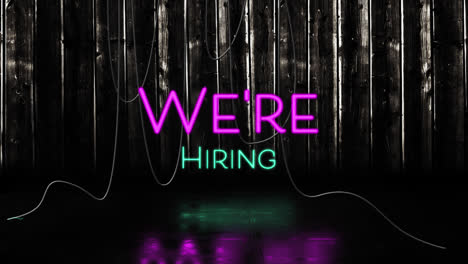 Animation-of-we're-hiring-text-in-pink-and-blue-neon,-with-hanging-cables-on-black-background