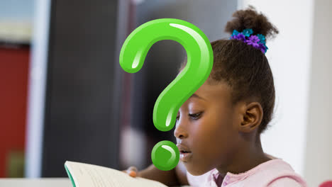 Animation-of-green-question-mark-over-african-american-schoolgirl-reading-in-classroom
