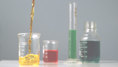 Animation-of-red-shapes-over-beakers-with-liquid-in-lab