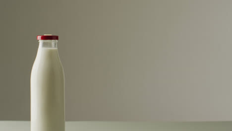 Video-of-glass-bottles-of-milk-on-white-background