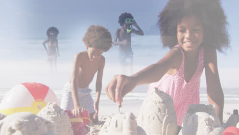 Composite-of-happy-african-american-brother-and-sister-making-sandcastles,-and-running-in-sea