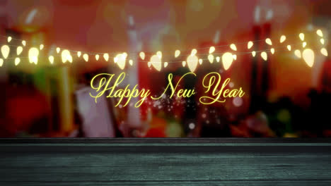 Happy-new-year-text-and-glowing-yellow-fairy-light-decoration-hanging-over-wooden-plank