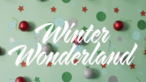 Animation-of-winter-wonderland-text-over-christmas-decorations