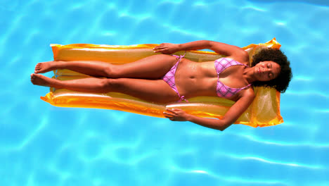 Glückliche-Frau-Entspannt-Sich-Auf-Luftmatratze-Im-Schwimmbad