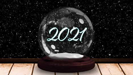 Shooting-star-around-2021-text-in-a-snow-globe-on-wooden-surface-against-black-background