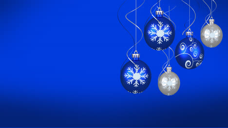 Animation-of-christmas-baubles-over-blue-background
