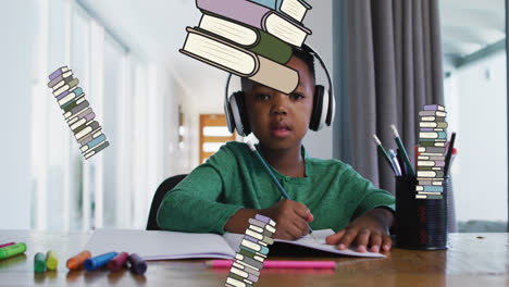 Animation-of-school-items-over-african-american-boy-learning-at-home