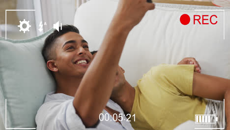 Animation-of-digital-interface-over-happy-biracial-male-gay-couple