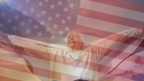 Animation-of-flag-of-united-states-of-america-over-senior-woman-having-fun