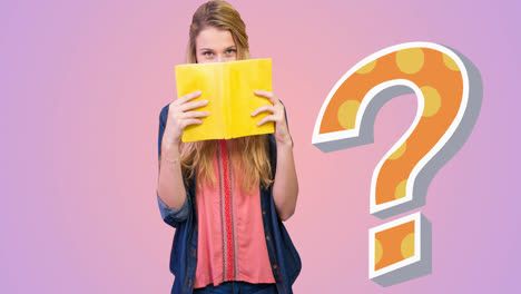 Animation-of-orange-spotted-question-mark-over-caucasian-woman-looking-over-book,-on-pink