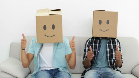 Silly-employees-with-boxes-on-their-heads-giving-thumbs-up