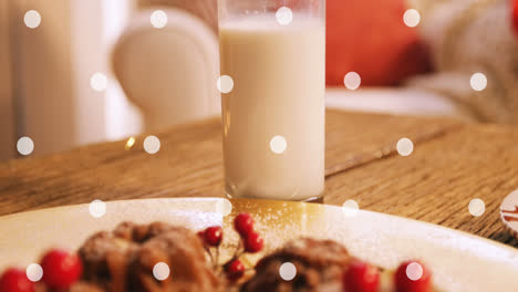 Animation-of-white-spots-over-milk-and-cookies-at-christmas