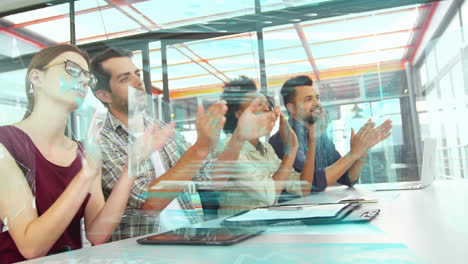 Animation-of-data-over-diverse-male-and-female-business-colleagues-clapping-hands-in-office