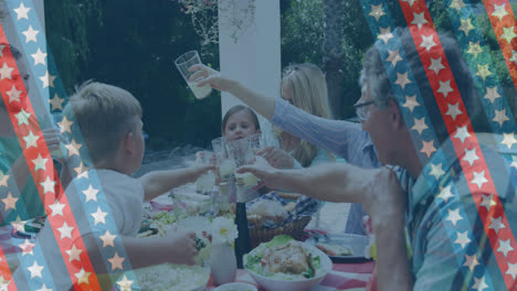 Animation-of-stripes-with-stars-over-happy-caucasian-family-eating-in-garden
