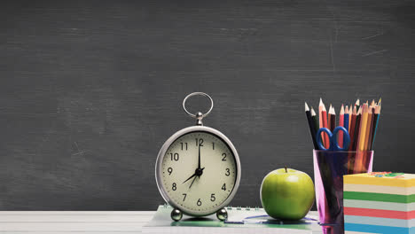 Animation-of-school-items-and-clock-on-green-background
