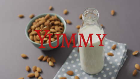 Animation-of-yummy-text-over-milk-and-nuts