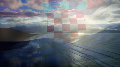 Digital-composition-of-waving-croatia-flag-against-aerial-view-of-beach-and-sea-waves