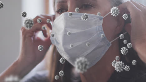 Animation-of-virus-cells-over-senior-caucasian-woman-with-face-mask