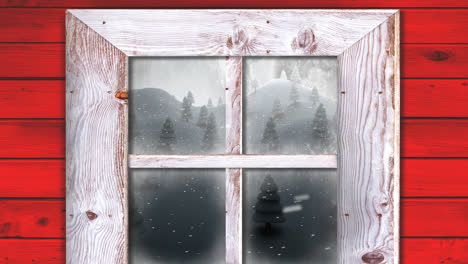 Wooden-window-frame-against-snow-falling-over-multiple-trees-on-winter-landscape