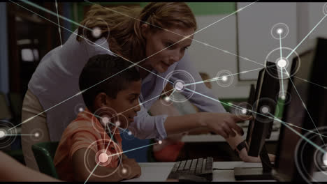 Animation-of-network-of-connections-over-diverse-boy-and-female-teacher-using-computers-at-school