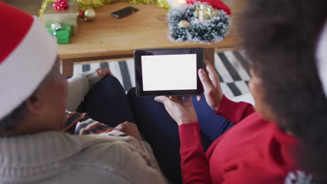 African-american-mother-and-adult-daughter-on-tablet-christmas-video-call,-copy-space,-slow-motion