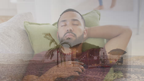 Animation-of-summer-tropical-beach-over-man-sleeping-on-sofa